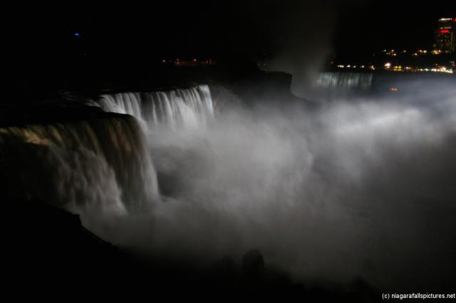 Horseshoe Niagara Falls at night lit by white light show.jpg