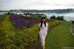 Joann and colorful flowers on Goat Island with Niagara Falls Horseshoe Falls in the background.jpg