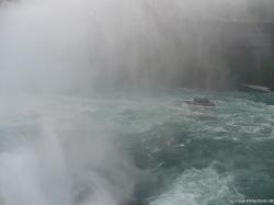 Maid of the Mist boat going into the mist created by Horseshoe Falls.jpg