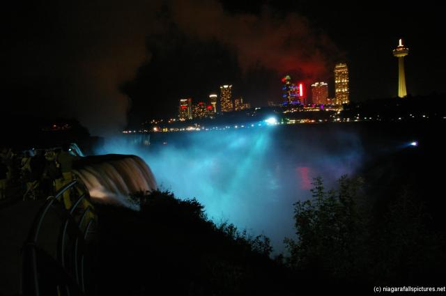 Niagara Falls at night light show in blue with Skylon Tower visible.jpg