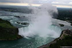 Photo of Horseshoe Falls with Toronto in the distance as viewed from Skylon Tower revolving restaurant.jpg