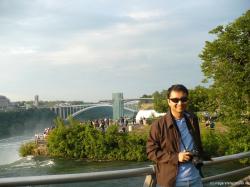 David leans against a rail at the American side of the Niagara Falls.jpg